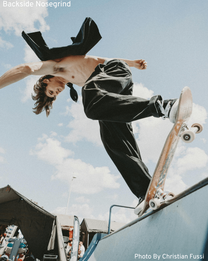 A cool skater executes a nosegrind trick on a mini ramp, demonstrating impressive skateboarding skills.