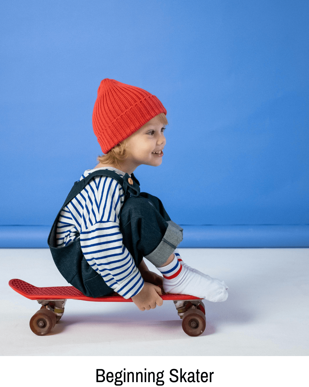 A young child on a skateboard with the text "beginning skater," illustrating a beginner skateboarder for skatershomebase.com.